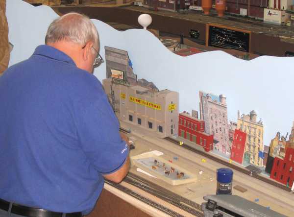 Rich Cutler working on the town of West Roxburgh on the layout of APN