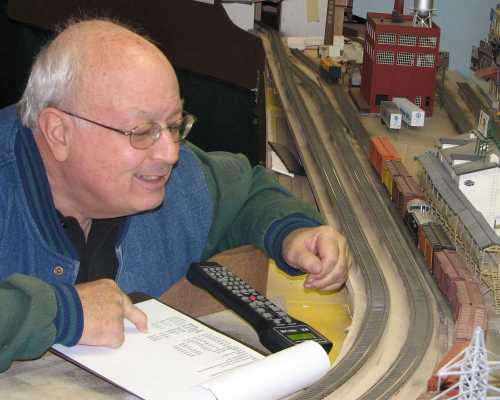 Rich Cutler checks box car road numbers against his switching list during a 2007 operating session at APN