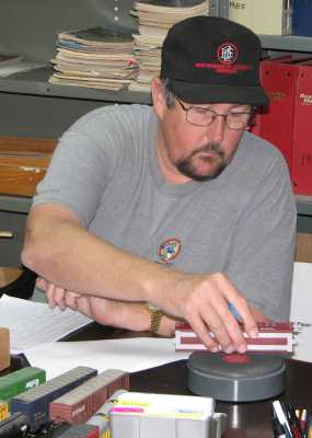 Randy Handley weighing a hopper in a car inspection work session at APN