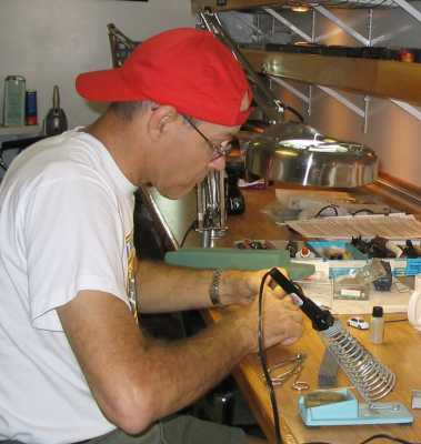 Ray McClure installing a decoder at the workbench at APN